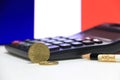 Twenty France euro cent on obverse on white floor with black calculator and pencil, France flag background. Royalty Free Stock Photo