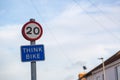 A twenty mile per hour sign with a think bike sign underneath in a street Royalty Free Stock Photo