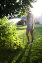 Young woman watering garden Royalty Free Stock Photo