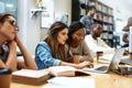 Twice the brainpower on this assignment. two young women using a laptop together in a college library.