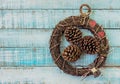 Twig wreath with paper hearts, vintage furniture and fircones on Royalty Free Stock Photo