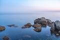 Twilght over the wild rocky beach coastline and the sea. Sea and rocks at night wide angle view Royalty Free Stock Photo