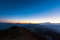 Twilight on Cattle Back Mountain with moon in the sky Royalty Free Stock Photo