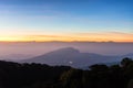 Twilight on clear sky before sunrise over dark mountains in shadow at Doi Inthanon National park. Chiang Mai, Thailand Royalty Free Stock Photo