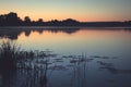 Twilight dark lake rustic countryside tranquil scenery landscape sunset with pink sky and tranquil water mirror reflections in vin Royalty Free Stock Photo