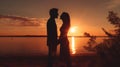 Twilight Embrace: Young Couples Silhouetted in Love Royalty Free Stock Photo
