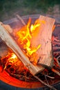 Twilight fire in a pit with logs on top of curling flame