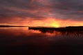 Twilight glow of the sky before the onset of the summer white night above the clear water surface of the lake