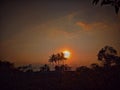 Twilight, golden orange sky as the sun sets below the horizon line to the west