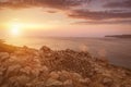 Twilight on the island of Crete near Spinalonga with a foggy horizon, sea coast, rocks and stones Royalty Free Stock Photo