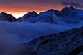 Twilight in the mountain. Foggy morning in Italian Alps, early morning in the mountain with snow during violet twilight, hills in