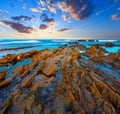 Twilight ocean coast with ribbed stratiform rock Royalty Free Stock Photo