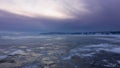 Twilight over a frozen lake. On the ice, the reflections of the setting sun Royalty Free Stock Photo