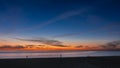 Twilight by the sea. In the blue sky there is an orange glow, purple clouds. Royalty Free Stock Photo