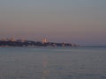 Twilight seascape with a city on the coast in the distance