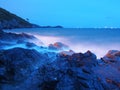 Twilight at seaside rocks and waves. Royalty Free Stock Photo