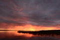 Twilight sky in the bright glow of sunset over the calm water of the lake Royalty Free Stock Photo