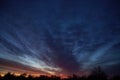 Twilight sky with clouds. Sunset and dark silhouette of trees on the horizon Royalty Free Stock Photo