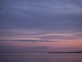 Twilight sky at the colorful blue and pink sunset and reflection in the water of the river. Panoramic landscape on the dusk Royalty Free Stock Photo