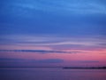 Twilight sky at the colorful blue and pink sunset and reflection in the water of the sea. Panoramic landscape on the dusk Royalty Free Stock Photo