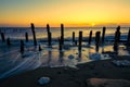 Twilight sky over soft motion sea and wooden posts. Spurn Point, East Yorkshire, UK.