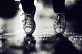 Twilight steps. Cropped image of a person wearing sneakers standing on their toes in the street. Royalty Free Stock Photo