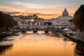 Twilight on Tiber river with sight of Vatican dome of Saint Peter Basilica and Sant`Angelo Bridge in Rome, Italy