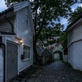 Twilight view of a colorful cobbled street in Bergen old town with typical wooden houses, Norway