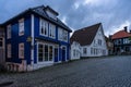 Twilight view of a colorful cobbled street in Bergen old town with typical wooden houses, Norway