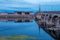 Blois, France. Twilight view of Jacques Gabriel bridge and city skyline reflected in water of Loire river.