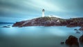 Twilight yields to dawn at Fanad Head Lighthouse. Smudges of clouds and misty water