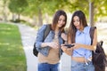 Twin Adult Mixed Race Sisters Sharing Cell Phone Experienc Royalty Free Stock Photo