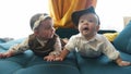 twin babies in retro clothes. brother and sister a twins kids sit on the couch lifestyle in retro clothes cap play among Royalty Free Stock Photo