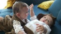 twin babies in retro clothes. brother and sister a twins kids sit on the couch in retro clothes lifestyle cap play among Royalty Free Stock Photo