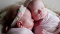 Twin babies sleep in the crib in dresses Royalty Free Stock Photo