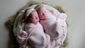 Twin babies sleep in the crib in dresses Royalty Free Stock Photo