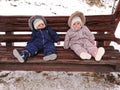 Twin babies swinging on a wood swing