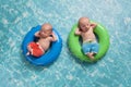 Twin Baby Boys Floating on Swim Rings Royalty Free Stock Photo
