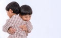 Twin boys hugging  on white background. Portrait of little son hugging brother or friend. I missing you. Full length happy boy emb Royalty Free Stock Photo