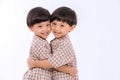 Twin boys hugging  on white background. Portrait of little son hugging brother or friend. I missing you. Full length happy boy emb Royalty Free Stock Photo