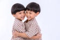 Twin boys hugging  on white background. Portrait of little son hugging brother or friend. I missing you. Full length happy boy emb Royalty Free Stock Photo