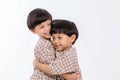 Twin boys hugging  on white background. Portrait of little son hugging brother or friend. I missing you. Full length happy boy emb Royalty Free Stock Photo