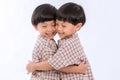 Twin boys hugging  on white background. Portrait of little son hugging brother or friend. I missing you. Full length happy boy emb Royalty Free Stock Photo