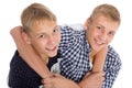 Twin brothers jokingly hugging each other