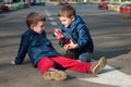 Twin brothers play with a toy car