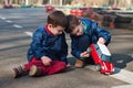 Twin brothers play with a toy car