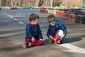 Twin brothers play with a toy car