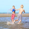 Twin brothers playing on the beach Royalty Free Stock Photo