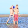 Twin brothers playing on the beach