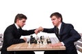 The twin brothers playing chess isolated on white Royalty Free Stock Photo